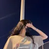 𝐵~