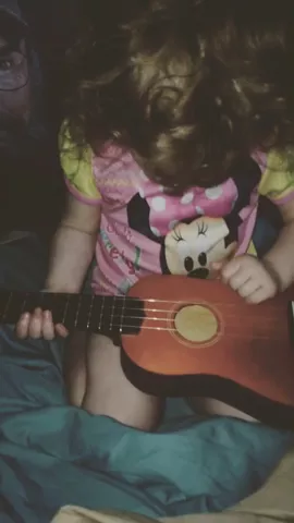 She's trying so hard to play my ukulele 