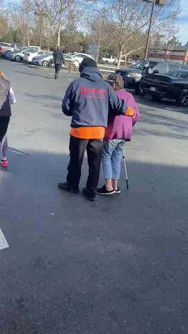 My dad helping a elder women who had a hard time walking to her car