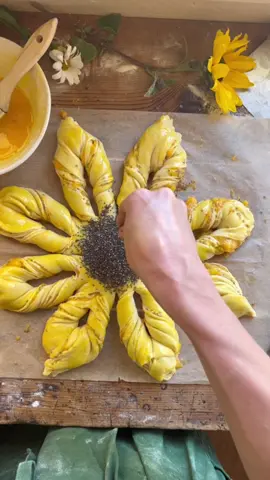 Sourdough Sunflower 🌻 Bread 335 g flour 95 Sourdough Discard (active)  160 g Milk  1 large egg 57 g butter 25 g sugar  3 g salt  3 g vanilla extract  Mix all ingredients together other than the butter.  Mix for 3-4 minutes then gradually add the butter.  At this point you could place the dough in a kitchen aid and knead until smooth.  About 5 minutes. Cover the dough and let rest in a warm spot for 8-12 hours.  Stretch and fold the dough 3-4 times during the resting period.  When ready, put the dough onto a lightly floured surface and divide dough into 4 equal parts.  Each part should be about 172g.  Now roll out each ball separately like a tortilla setting aside as finished.  Place the dough on a lightly floured surface.   Put one “tortilla” on the floured surface and spread peach jam on bottom layer.  Gently place next “tortilla” on top and spread peach jam on top.  Repeat this step using all 4 but leaving the last layer without any jam on top.   Place something circular in the middle of the dough layers.  Now cut into 16 equal parts.  Once you have 16 parts, grab two (they will be pairs) and twist away from each other about 4-5 twists and then pinch the ends together.  Your sunflower 🌻 will have 8 petals at this point.   Brush egg wash over bread and sprinkle chia seeds in the middle for the sunflower “seeds”.   Bake for 20 minutes at 400 degrees.   Summer Peach 🍑 Chia Seed Jam  4-5 cups Peaches 3-4 TBS Honey  5-6 tsp Chia Seeds  Chop and peel fresh peaches and remove pit.  Heat a medium saucepan over medium heat and add chopped peaches and honey.  Stir until peaches have softened and they are starting to fall apart.  At this point, add the chia seeds and stir to a slow boil.  Use a fork or masher to break up peaches.  Stir peach mixture for about 15-20 minutes until it coagulates into a jam-like mixture.  Store the jam in a jar and let cool before covering. Let cool for 2 hours or up to overnight before refrigerating.   ENJOY!!