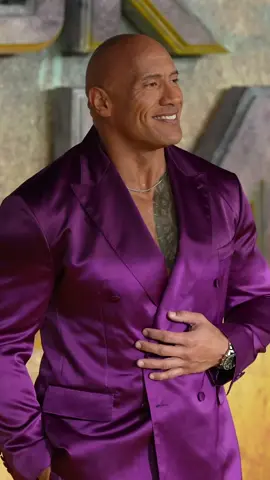The Rock rocking the #RedCarpet 👀 Dwayne Johnson attends the UK premier of Black Adam in a purple tuxedo. 🔥 [📷 Getty Images]