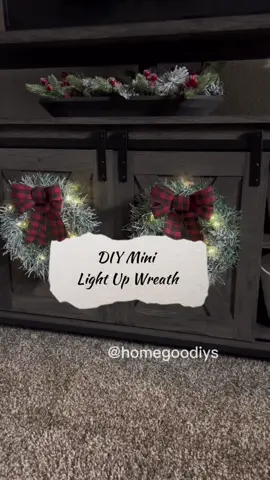 🎄DIY Mini Flocked Wreath w/ Lights🎄Hey TT fam! 🫶 Here’s an easy tutorial to create a small wreath for your cabinet doors. I hung mine on the doors of my TV stand. I didn’t use any tools for this, not even hot glue! 😃Here are the supplies you’ll need: Dollar Tree: 🎄Small wreath form- these come in a pack of two  🎄15ft garland- I used one pack for each wreath  🎄Bows of choice- the one I’m using comes in a pack of two 🎄Large adhesive hooks to hang  The faux snow is from Walmart, and the fairy lights are from Amazon. I have the lights linked in my bio.  That’s it, hope you enjoy! 🤗  #dollartreecrafts #DIY #homegoodiys #budgetfriendlydecor #diychristmasdecor #diychristmas #dollartreediyprojects #diyhomedecoreasy #easydiydecor #easyhomedecor 
