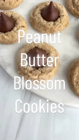 Peanut butter blossom cookies! Recipe on cakemehometonight.com! #cookie #cookies #christmascookie #christmascookies #holidaybaking #christmasbaking #peanutbutter #peanutbutterblossoms #hersheys #hersheyskisses #hersheyskiss 