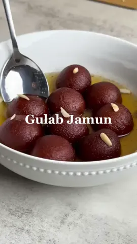 The perfect homemade Gulab Jamun 🤤 (my mom would be so proud.. even though the last time she made them, they were burnt 😂 sorry mom) You HAVE to try these, even if you’ve never had Gulab Jamun before! They are sweet little balls of delight perfect for any occasion 😍 Servings: 12 gulab jamun Ingredients: 	- 1 cup milk powder (100g) 	- 3 tbsp flour (30g) 	- 1 1/2 tsp baking powder 	- 1 egg  	- 3 tbsp cream (40g) 	- 2 tbsp ghee (30g) 	- 1 1/4 cups water 	- 1 cup sugar  	- 1-2 cardamom pods Method:  - Mix the milk powder, flour and baking powder in a bowl - Separately whisk together the melted ghee, egg and cream - Pour into the dry ingredients and use a spoon to bring together into a dough - Lightly knead the dough to make sure there are no lumps and refrigerate for 20 min - Knead the dough again when it’s cooled to make sure it is smooth - Form into small balls (jamuns) about 20g each. Apply light pressure between your palms while circling one palm, and lightly roll to form perfect balls. Make sure there aren’t any large cracks on them. Put back in the fridge - Mix sugar, water and cardamom in a saucepan and bring to a boil. Simmer for 5 min then take off the heat - Heat 2” of oil or ghee in a wok  - Once the oil is warm (but not too hot, test with a small piece of dough - it should rise to the surface slowly), gently transfer half of the balls - Swirl your wok so the jamuns start to float and turn, then use a large strainer to gently swirl them as you fry them. Fry for 4 min until they are evenly brown - Strain the jamuns while you reheat the syrup. Once boiling, put them into the strip and simmer for 5 min on medium heat. Make sure they are well coated. Cover and rest for 30 min  - Serve and enjoy! #gulabjamun #gulabjamunrecipe #pakistanidessert #indiandessert #mithai 