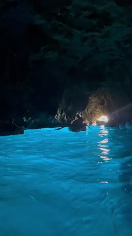 The Blue Grotto is a natural sea cave. To enter visitors must board small rowboats. Inside, pass from complete darkness into a sparkling cavern, lit by azure blue light, while the sounds of ancient Neapolitan song echo along the stone walls. 🛶 . . #bluegrotto #capri #italy🇮🇹 #italy #boat #grottaazzurra #napoli #cave #sea #nature #blue #bluelight #beach #volare #italian #vacation #beautifuldestinations #fyp 