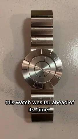 90s Issey Miyake TO SILAN001 Minimal Silver Watch Designed by Tokujin Yoshioka, a Japanese designer who often toyed with minimalism - this watch sits free of any straining numbers or symbolism, creating a sleek round figure. The unique clasping mechanism permanently sits attached, expanding with two buttons and folding inwards to remain hinged. The overall stature of this accessory is alluring, ironic due to the seemingly low effort design. This watch is a testament to contemporary design, Yoshioka using depth to create a sense of personality. #isseymiyake #isseymiyakefan #yohjiyamamoto #design #watches #watchtok #kansaiyamamoto #rafsimons #margiela #rickowens #archivefashion #fashion #style 