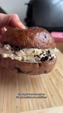 a toasted blueberry sourdough bagel w/ vanilla bean chocolate PB cream cheese. Blueberry sourdough bagel recipe will be on my site tmrw #dessert #sourdough #bageltok #sourdoughbread #bagels  