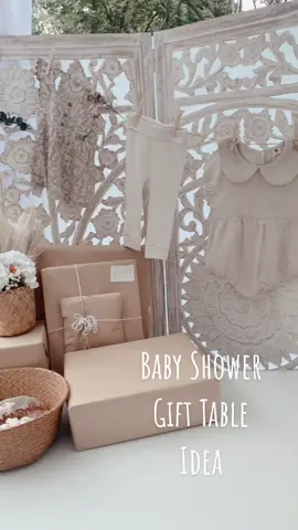 Baby shower gift table idea 🤍 featuring our wood carved divider, faux eucalyptus, and baby clothes hanging from pins 😍 #babyshower #babyshowerideas #babytok #babyshowerthemes 