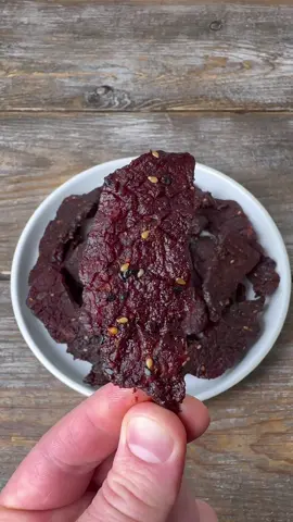 The best snack: Beef Jerky  Recipe  • trim all of the fat off of a partially frozen 2-3 lb eye of round roast, then slice it in half the long way. • Cut slices into 1/4 inch thick pieces  • Make marinade out of  > 1/4 cup Korean BBQ rub from spiceology  > 1/2 cup Bachans  > 1/3 cup brown sugar  > 2 tbsp ginger paste  • Combine slices of meat and marinate in a ziploc bag and let it marinate for 12-24 hours  • Smoke at 165F for 6 hours until it becomes translucent and you can easily pull it apart #snack #Recipe #beefjerky #smokedmeat #protein #foodprep #cooking 