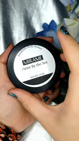 ✴️Three By the Sea Signature, Premium Body Butter✴️ Hello Everyone! 🧡 I just received this Premium Body Butter by Mirameswim. I love the smell of this body butter, it's like a tropical scent but not overpowering. It feels really soft and smooth after the application. This product is made of great ingredients, its so hydrating on the skin, but it doesn't feel greasy at all. For more information about this brand and their products, please follow their social media platforms and their official website. ✴️About The Product:✴️ ✨This decadent body butter will transport you to the sea. With hints of citrus, and grounding notes of wood, you will take an olfactif journey to a grove by the Carribean Sea. This custom blend was inspired by Founder Melinda’s time living in her Mother’s homeland of Honduras. ✨The butter is hand made in small batches in New York. ✨Ingredients include:  Water, Coconut Oil, Sunflower Oil, Cocoa Butter, Cetearyl Alcohol, (ad) Ceteareth, Shea Butter, Extra Virgin Olive Oil, Glyceryl Stearate, Stearic Acid, Carbomer, Optiphen Plus, Fragrance 🛒Link To Shop: https://mirameswim.com/ #bodybutter #skincare #skincareroutine #mirameswim #skincarereview #sheabutter #sunflower #extravirginoliveoil  #flatlay #beautyflatlay #socialcat @socialcathq 