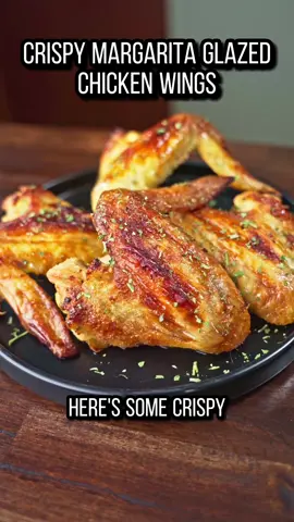 These wings were so good! The Margarita Glaze really took these baked wings up a notch! Make sure you use the baking powder trick for some perfectly crispy wings!  12 whole wings or 24 divided pieces 1 tbsp baking powder Salt and pepper Juice of 1 orange, 1 lemon, and 2 limes 1/4 cup Tequila 1/4 cup honey 1. Preheat the oven to 450F 2. Combine salt, pepper, and the baking powder, then add to a large ziplock bag with the wings and shake to coat.  3. Let them rest doe 10-15 minutes on a wire rack before placing in the oven.  4. While they bake for 25-30 minutes, start making the glaze. 5. Add all of the citrus juice, tequila, and honey to a pan and bring to a simmer while stirring occasionally and resuce by about 1/3 6. After the wings are done, brush on the glaze and bake again for 10 more mins 7. Take out the wings, glaze again, and enjoy! #chickenrecipe #chickenwings #chickenwingrecipe #margaritachicken #margaritachickenwings #citruschicken #citruschickenwings #chickenwinghack #crispychickenwings #bakedchicken #bakedchickenwings #Foodie #FoodTok #chicken 