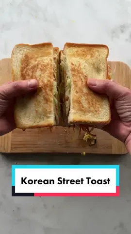 Korean Street Toast or Gilgeori Toast , the ultimate breakfsst sandwich packed with veggies and layered with smoky ham, sharp cheddar cheese, and drizzles of mayo and ketchup or sriracha!  So good and so easy!   For more details, check out the blog post link in bio #koreanfoodlover #koreanstreettoast #koreanstreetfood #gilgeoritoast #koreanfoodtiktok #EasyRecipe #breakfastsandwichrecipe 