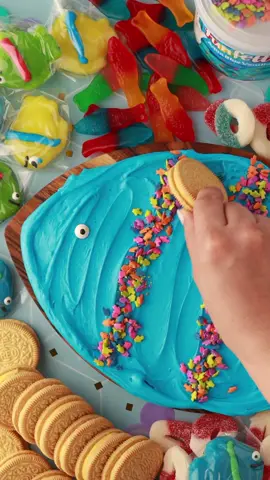 It's oh-fish-ial! We are OBSESSED with frosting boards😍🐟⁠ ⁠ Want to make one this summer?⬇⁠ ⁠ You'll need...⁠ 1 tub Funfetti Aqua Blue Vanilla Frosting⁠ Assorted cookies, pretzels, candies⁠ ⁠ Directions:⁠ 1. Using a flat spatula or butter knife, carefully spread frosting onto a clean food-safe board in the shape of a fish.⁠ ⁠ 2. Top with sprinkles from frosting lid to decorate.⁠ ⁠ 3. Place desired snacks around the board to dip into the frosting and enjoy! @theoreoofficial  #funfetti #fyp #oreo #frostingboard #frosting #butterboard 