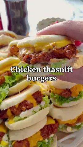 CHICKEN THASNIFT BURGERS #burger #chicken #Recipe #food #fyp #fy #foodtiktok #viral #crunchy #thasnift #trending #cheese #LearnOnTikTok  DOUGH 450 g all purpose flour 20 g granulated sugar 10 g yeast 8 g salt (1⅓ tsp) 75 g yogurt 25 ml sunflower oil 200 ml warm water   CHICKEN MIXTURE 550 g chicken breast 250 ml buttermilk 1 egg (m) 7 g salt (1⅙ tsp) 8 g onion powder (2⅔ tsp) 5 g garlic powder (1⅔ tsp) 5 g paprika powder (1⅔ tsp) 4 g cayenne pepper (1⅓ tsp) 50 g chili sauce   FLOUR MIX 150 g all purpose flour 100 g cornstarch 5 g garlic powder (1⅔ tsp) 5 g onion powder (1⅔ tsp) 3 g cayenne pepper (1 tsp) 3 g salt (½ tsp) 50 ml buttermilk mixture (see step )   SAUCE 100 g mayonnaise 50 g cream cheese 50 g corn 70 g cucumber 50 g carrot 30 g yellow onion 30 g pickles   STICKY SAUCE 150 g chili sauce 75 g honey 50 g samurai sauce 10 g sambal   Put the flour, sugar, yeast, salt, yogurt, sunflower oil and warm water in a bowl. Knead for 10 minutes. Cover the dough and let it rise.   Wash and cut the chicken breast into flat pieces. Put the buttermilk together with the egg, salt, onion powder, garlic powder, paprika powder, cayenne pepper and chili sauce in a bowl. Mix well. Add the chicken and cover it. Put it in the refrigerator for 30 minutes. Scoop out 50 ml of the mixture and set it aside.   Put the flour, cornstarch, garlic powder, onion powder, cayenne pepper, salt, and mixture in another bowl. Crumble with your hands.   Coat the chicken with the flour mixture. Put the chicken on a sheet of baking paper.   Divide the dough into 20 equal pieces (37 g each). Take a ball of dough and flatten it to a size of 7.5 cm. Let the dough rise.   Cut the cucumber into small pieces. Grate the carrot, pickles, and yellow onion. Put the mayonnaise,  cream cheese, corn, cucumber, carrot, yellow onion, and pickles in a bowl and mix.   Heat a pan with a thick bottom over medium heat. Fry the buns on both sides until golden brown and cover them with a kitchen towel.   Heat a layer of sunflower oil in a frying pan over medium heat (170 °C). Fry the chicken until crispy and golden brown.   STICKY SAUCE Put the chili sauce, honey, samurai sauce, and sambal in a saucepan. Cook over medium heat until smooth. Coat the burgers with the sauce.    
