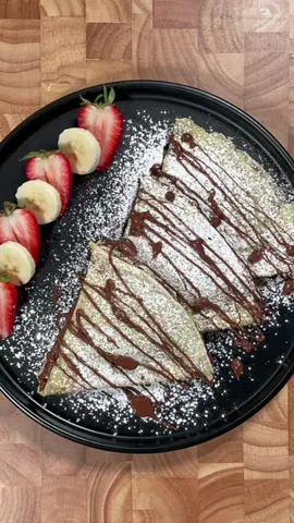 French crêpe 🇫🇷🤯 Ingredients: 2 eggs  310ml milk  30g melted butter  1 Tbsp sugar  125g all purpose flour  Method:  1. In mixing bowl place eggs and milk and whisk well.  2. Add the melted butter and sugar and mix until combined.  3. Add the flour and mix until fully incorporated (use hand blender or blender for best result)  4. Strain through strainer to make sure the batter is smooth.  5. Heat a pan to a medium high heat and grease it with butter 6. Pour 1/2 cup of the butter and tilt the batter to the sides so that the entire pan has an even layer of batter.  7. Fry the batter for 1-2 minutes and flip and fry again 1-2 (you’ll see when it’s ready) 8. Fold the crepe into into half a spread with Nutella and fold again (see example in the video)  9. Serve right away dust with powdered sugar and drizzle more of the Nutella.  Enjoy 😉  #french #frenchcrepe #crepe #homemade #homemadefrenchcrepe #frenchcrêpe #france #france🇫🇷 #frenchdessert #dessert #desserts #nutella #bananas #straberry #butter #crepe 