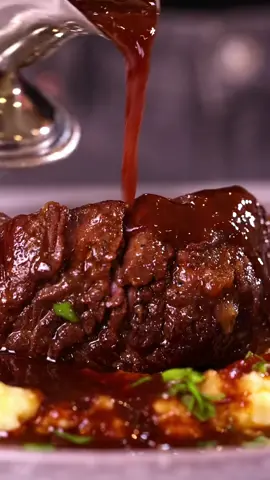 Beef braised short ribs: Ingredients: * 4 pounds beef short ribs * Salt and black pepper to taste * 2 tablespoons vegetable oil * 1 large onion, chopped * 3-4 carrots, chopped * 2 celery stalks, chopped * 4 garlic cloves * 2 tablespoons tomato paste * 2 cups red wine * 2 cups beef broth * 2 sprigs fresh thyme * 2 bay leaves Instructions: 1. Preheat your oven to 360F 2. Season the short ribs generously with salt and black pepper. Heat the vegetable oil in a large Dutch voven or oven-safe pot over medium-high heat. 3. Working in batches, sear the short ribs on all sides until they are browned and crispy. This will take about 5 minutes per batch. Remove the ribs from the pot and set them aside. 4. In the same pot, add the chopped onion, carrots, celery, and garlic. Sauté the vegetables until they are softened and lightly browned, about 5 minutes. 5. Stir in the tomato paste and cook for an additional 2 minutes to enhance its flavor. 6. Pour in the red wine and scrape the bottom of the pot to release any browned bits. Allow the wine to simmer for a few minutes until it has reduced slightly. 7. Add the beef broth, thyme sprigs, and bay leaves to the pot. Return the short ribs to the pot, nestling them into the liquid. 8. Cover the pot with a lid and transfer it to the preheated oven. Braise the short ribs for about 2.5 hours, or until the meat is tender and falling off the bone. 9. Once the short ribs are cooked, remove them from the pot and set them aside. Skim any excess fat from the surface of the cooking liquid. 10. Strain the cooking liquid into a saucepan and simmer it over medium heat until it has reduced. 11. Serve the short ribs with the braising liquid or sauce, and accompany them with mashed potatoes.#braisedbeefshortribs #ribs #dutchoven#cooking 