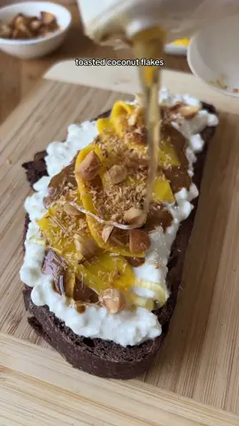 dark chocolate sourdough bread topped with probiotic cottage cheese, almond butter, mango, raw honey, toasted coconut and macadmias #sourdoughbread #sourdoughtoast #cottagecheesetoast  #sourdough #almondbuttertoast  