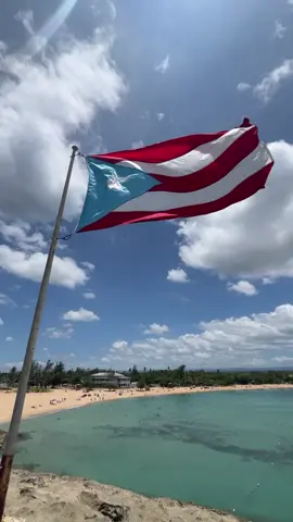 Colors of Pride: The Puerto Rican flag 🇵🇷waves proudly against the backdrop of the breathtaking Mar Bella Beach in Vega Baja, capturing the essence of beauty and heritage in one mesmerizing view. #puertorico #vegabaja #marbella