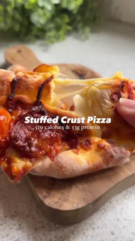 Stuffed crust air-fryer pizza 🍕 519 calories and 43g protein! #stuffedcrustpizza #highprotein #airfryerrecipes #fyp #foryou Macros 519 calories 43gP / 17gF / 47gC Serves: 2 (makes 2 pizzas!)   Shopping list ✍️  - 100g self raising flour  - 150g 0% Greek yogurt  - 2 cheese strings - 40g tomato purée - 2 tsp oregano  - 100g passata  - Cherry tomatoes, sliced  - 40g chorizo or pepperoni, sliced  - 100g cooked chicken, diced - 30g mozzarella - 1-2 tsp sweetener - Salt & pepper Method Mix together the passata, tomato purée, 1 1/2 tsp oregano, sweetener then salt and pepper and leave it to one side. Mix the flour and Greek yogurt to make a dough then divide into two. Roll out each dough ball then slice the cheese string and place spread out at the edge of the dough.  Roll the outside of the dough over the cheese string to make a crust and make sure it’s pressed down (be gently!) to enclose the cheese. Place in the air fryer then spread over your homemade marinara sauce, the toppings then finally a pinch of oregano per pizza.  Air fry on 190C for 12-15 minutes and enjoy! 
