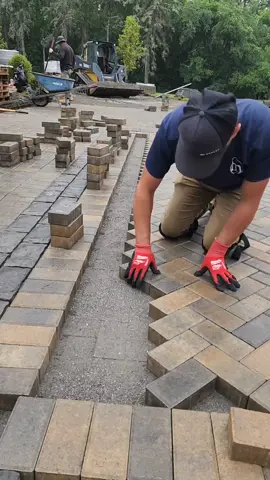 Rain Or Shine 🌧️🧱#amlandscaping #brick #paver #driveway #curbappeal #inlay #herringbone #layout #design #hardscaping #front #design #fyp #foryou #foryoupage 