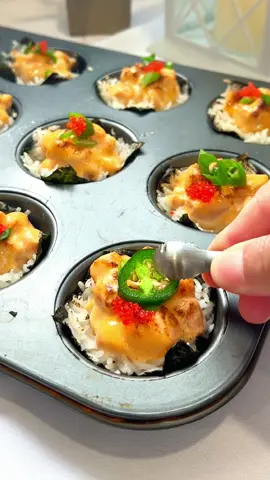 You gotta try these bite sized goodies: Salmon Sushi Cups  Visit the link in my bio for the best spicy mayo combo with @@Chinsu_Hot_Sauce  Servings: 15 salmon sushi cups  STEP 1:  - Cut seaweed sheets - Evenly spread calrose rice onto seaweed sheets  - Transfer to a cupcake/muffin tin STEP2:  - Cut approximately 10oz of salmon into bite sized pieces  - Set aside  STEP 3: COMBINE - 2.5 tbsp of mayo  - 2 tsp of granulated garlic powder - 2 tsp of soy sauce  - 2 tsp of sesame oil  - Drizzle of Chin-Su Original Hot Sauce STEP 4:  - Transfer salmon into spicy mayo mix  - Add spicy salmon blend into seaweed rice cups onto cupcake/muffin tins STEP 5:  Option 1: Bake at 350 degrees for 5 mins Option 2: Torch & sear  STEP 6:  - Top with tobiko, chopped scallions, jalapeño peppers & Chin-Su Original Hot Sauce