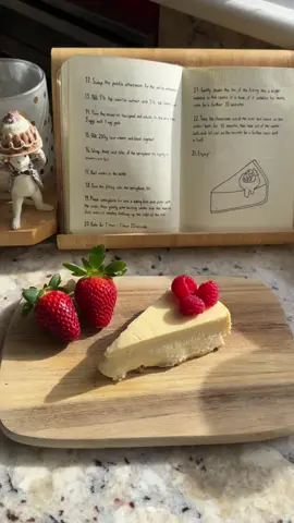 Cheesecake 🍰🍓 Recipe based on: bbcgoodfood.com “New York cheesecake”  Crust: - 85g unsalted butter, melted - 140g crushed biscuits. (I use butternut biscuits) - 1 tbsp caster sugar Filling: - 900g cream cheese - 250g caster sugar - 3 tbsp plain flour - 1 + 1/2 tsp vanilla extract - 1 + 1/2 tsp lemon juice - 3 eggs - 1 egg yolk - 200g sour cream Method: Combine all crust ingredients and place in a springform tin, bake at 180 Celsius for 10 mins, remove from oven and cool. Reduce temp to 140 Celsius and combine all filling ingredients in the order of the video. Wrap the tin in foil and pour the filling in the tin. Bake in water bath for 1 hour- 1 hour 20 mins. If the filling is slightly wobbly it is done, if it wobbles too much bake for 10 more mins. Take cheesecake out of the oven but leave in water bath for 45 mins, take out of water bath and let cool on the counter for a further hour and a half, then refrigerate for a few hours. Refrigerating for longer or overnight will ensure the filling is more solid and is much easier to cut. When cooled run a knife around the edge of the tin and serve.  Recipe based on: bbcgoodfood.com “New York cheesecake” 🫶🏻 #baking #fyp #taylorswift #cardigan #viral #baketok #aesthetic #getmefamous #trending #Summer #foryoupage #yummy #vanilla #cheesecake #fruit 