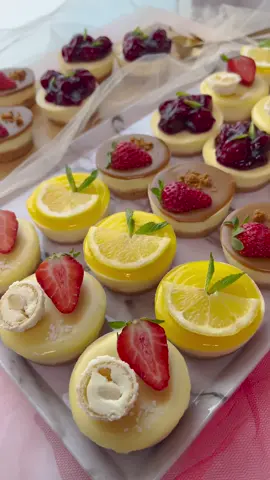 MINI CHEESECAKES #Recipe #food #cheesecake #cake #foryou #fy #fyp #trending #viral  COOKIE DOUGH 200 g Maria biscuits 175 g unsalted butter   CHEESECAKE BATTER 800 g cream cheese 8 g vanilla sugar  175 g granulated sugar 60 g cornstarch 4 eggs (m)   TOPPING Biscoff spread Lemon curd   WHITE CHOCOLATE GANACHE 50 ml heavy cream  200 g white chocolate     Melt the unsalted butter in a saucepan over low heat.   Put the Maria biscuits in a food processor and grind them into fine crumbs. Add the melted butter and mix.   Divide the cookie dough into the muffin tin/silicone molds (15 grams). Press it firmly against the bottom (use a glass with a cupcake liner/parchment paper underneath). Place them in the refrigerator   In a deep bowl, combine the cream cheese, sugar, and vanilla sugar. Mix for 1 minute. Sift the cornstarch into the bowl and mix again for 1 minute. Put away the mixer and use a spatula from now on. Add the eggs one by one into the bowl, whisking until each egg is fully incorporated. Continue to fold the batter until it becomes smooth and airy.   Pipe the cheesecake batter (45 grams per portion) over the cookie dough.   Place the mini cheesecakes in a preheated oven at 115°C (235°F). Bake them for 22-25 minutes. Turn off the oven and let the mini cheesecakes cool slowly with the oven door closed to prevent cracking. I usually leave the cheesecakes in the oven for an hour and then store them covered in the refrigerator (preferably overnight).   Warm the Biscoff spread over low heat in a saucepan. Keep an eye on it as it heats up quickly. Transfer the Biscoff spread into a piping bag.   Heat the heavy cream until it's just about to boil. Add the broken white chocolate and let the mixture sit for 1-2 minutes to allow the chocolate to melt. Stir everything together with a spatula until the mixture is smooth. Place the white chocolate ganache in a piping bag.   Gently warm the lemon curd in a saucepan while stirring. Remove the pan from the heat when it begins to liquefy. Transfer the lemon curd into a piping bag.   Decorate the mini cheesecakes with a layer of Biscoff spread, white chocolate ganache, lemon curd, and cherry pie.  