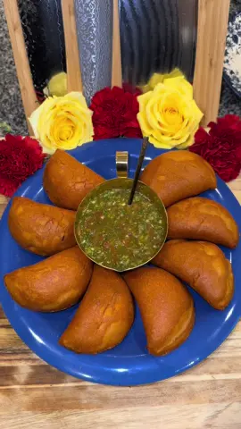 Colombian Empanadas🇨🇴 (stuffed with slow cooked beef and potatoes) #empanadas #colombian #colombianempanadas #Recipe  In a slow cooker add: -olive oil  -2 medium yellow onions (diced) -1 large tomato (diced)  -2 bell peppers (diced) -11 cloves of chopped garlic -about 1 cup of beer  -season with: Cumin, Chicken Bouillon Powder, Sazon and Adobo  Mix this together  Then get a 2.5 to 3 lb chuck roast and pat it dry with a paper towel.  Add salt to both sides, and then in a pan on medium heat with oil, brown it on both sides. Then add it on top of the vegetables and season with the same 4 seasonings.  Let this cook on low for 8 hours, and then when there’s about 3 hours left of cooking, add 5 to 7 peeled and cubed gold potatoes (submerging them into the broth) When it’s done, use a slotted spoon to separate the meat and vegetables from the broth, (the meat will shred while you’re mixing it all together, use a fork or tongs) Then for the dough, you’re going to get Masarepa, which is Pre-cooked Yellow cornmeal (PAN is a popular brand in Colombia but you can find it at Publix)  Add 2 cups to a bowl and then season with Cumin, Chicken Bouillon Powder and Sazon  Then strain the broth from your crock pot, and remove all the fat from the top. Make sure the broth is warm and slowly stir it into the Masarepa Once it’s too firm to be stirred, start to knead it with your hands until it has a play-dough like texture. Make sure to cover it up with plastic wrap (even when you’re using it) so it does not dry out.  Then get a tortilla press, and add plastic wrap to both sides with a little oil (also add a little to your hands)  Then roll the dough into balls, and press it with your tortilla press (you can also use the bottom of a plate if you don’t have a press. Just place the dough between 2 pieces of plastic wrap while pressing down with the plate)  Make sure your filling is cooled to room temperature, and then add it to the center.  Then fold it over with the plastic wrap and smooth down the edges.  Use a bowl to cut out the empanadas (I like using a small bowl like this one, just remember the larger the bowl the larger the empanadas)  Then in a pot on medium to medium high heat, fry them until they’re golden brown letting them rest on a paper towel or cooling rack  You can’t serve Colombian Empanadas without Aji Picante, (so I’ll posting the recipe for this tomorrow) Enjoy💜
