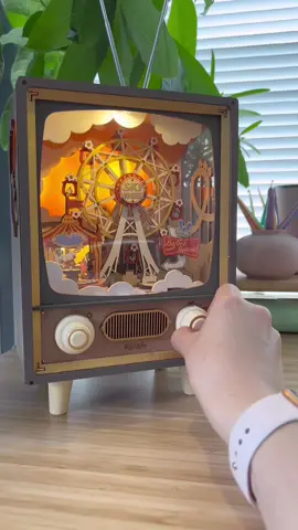 Sometimes I need a break from crochet… So I spent a quiet afternoon building another DIY miniature kit from @RolifeOfficial Miniature 🎡 This one is called Sunset Carnival. It’s a little amusement park scene inside a retro TV shaped box. It lights up and plays music and the little rides even spin around! (Use the link in my bio to get your own miniature kit. They have adorable miniature houses too!) #rolife #musicbox #diyminiature #craftkit 