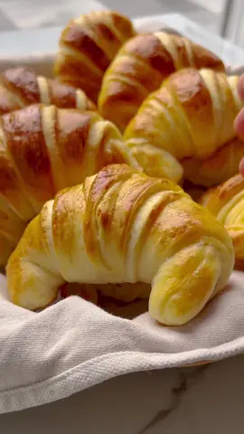 SOFT CRESCENT ROLLS   #soft #croissant #rolls #bread #Recipe #food #fy #foryou #fyp #foryoupage #tiktokffood #foodtiktok   DOUGH 400 gr flour (all-purpose flour) 7 gr instant yeast (1 tablespoon - 1 packet) 15 gr granulated sugar (1 tablespoon) 7 gr salt (1⅙ teaspoons) 35 ml of sunflower oil 225 ml of water   EXTRA 40 gr unsalted butter 1 egg (medium-sized)   Combine the flour with the yeast, sugar, salt, sunflower oil, and water in a deep bowl. Mix well and knead for 10-12 minutes until a smooth dough forms.   Allow the dough to rise for 1 hour in a warm place or until it has doubled in size.   Divide the dough into two pieces.   Place the dough on a floured work surface and roll it out into a round sheet. Repeat these steps with the remaining dough.   Spread the dough with butter and place the other piece of dough on top. Cut the dough into 12 triangles.   Shape the crescent rolls: Take a triangle of dough and gently stretch it.   Roll up each triangle from the wide base to the tip to create the crescent shape.   Place the crescents on a baking sheet lined with parchment paper. Brush them with the beaten egg and let them rise for 30 minutes or until the dough has doubled in size.   Place the crescent rolls in a preheated oven at 200 ℃ (392 ℉). Bake for 10-15 minutes or until the rolls are nicely golden brown. Keep an eye on the baking time as every oven varies.       Tips:   Allow the dough to rise in a warm place to make the croissant rolls light and airy. Cover the dough immediately with a clean kitchen towel as soon as the rolls come out of the oven.    