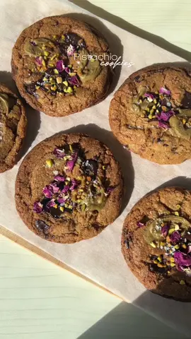 Pistachio cookies 💚 recipe below: Ingredients 🧈 -200g butter -100g coconut sugar -100g white sugar -1 egg + 1 egg yolk -2 tablespoons pistachio paste -230g all-purpose flour -1 teaspoon baking soda -1 bar of dark chocolate For decoration: -Crushed pistachios -Pistachio paste -Coarse sea salt -Edible rose petals Instructions 📝 Melt the butter until it becomes nutty (brown butter). Mix the brown butter with the brown sugar and the pistachio paste. Add the egg and egg yolk to the mixture and stir until well combined. Incorporate the all-purpose flour and baking soda, mixing until a dough forms. Roughly chop the dark chocolate and add it to the dough. Cover the dough and refrigerate it for at least 2 hours. Preheat your oven to 190°C (375°F). Take the chilled dough out of the refrigerator and shape it into small balls.  Place them on a baking sheet lined with parchment paper. Flatten each cookie slightly with your fingers. Bake the cookies in the preheated oven for approximately 12 minutes or until the edges turn golden brown. Once baked, allow the cookies to cool completely on a wire rack. To decorate, spread a little pistachio paste on top of each cookie, then sprinkle some crushed pistachios, a pinch of coarse sea salt, and a few edible rose petals. Enjoy your delicious pistachio cookies! #cookies #Recipe #pistachio #chocolate #bake #FoodTok 