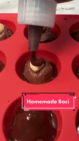 HOMEMADE BACI! Have you ever had Baci? If not you are missing out! Truth is I bought all the ingredients to try and make homemade Snickers, but my heart wasn’t into it. I started to think about the chocolate I loved as a kid and this was it!! 1/2 cup hazelnut spread 1/2 cup almond flour 1/4 cup chopped hazelnuts 18 ounces dark chocolate chips 1 tbsp coconut oil 18 hazelnuts -To a medium sized bowl, add hazelnut spread, almond flour and chopped hazelnuts. Mix well and place in refrigerate.  -To another medium sized bowl add dark chocolate chips and coconut oil. Mix and place in the microwave. Heat in 30 second intervals, mixing in between. It should take no more than 90 seconds.  -Add chocolate to a plastic bottle.  -Assemble your homemade Baci as shown. Keep in refrigerate until it’s time to eat.