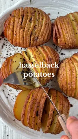 Hasselback Potatoes 🥔🧄🍃 Say hello to crispy layers of garlic rosemary potatoey goodness! It’s perfect as a side dish for any meal or simply as a snack on its own 🤌🏼 Ingredients:  1kg or 5 medium russet potatoes, scrubbed and dried  3 tbsp olive oil  5 cloves garlic, minced  3 springs fresh rosemary, leaves only Salt and pepper  Method:  1. Preheat the oven to 180°C fan forced or 200°C conventional. Line a baking tray with baking paper and set aside. 2. Cut thin slits into the potato, stopping just before the bottom. You can also slice a tiny piece off the bottom to make it flat and easier to work with. Another option on top of that is to put chopsticks on either side to help guide you. Repeat with all the potatoes and place onto the baking tray.  3. Mix the oil, garlic and rosemary. Use a spoon or a brush to coat all the potatoes in the oil mix, ensuring you get into all of the gaps.  4. Bake in the oven for a total of 1 hour. At the halfway mark you can brush them with a little extra oil before returning to the oven for the remaining 30 min.  5. Remove from oven and generously season with salt and pepper. Enjoy.  #plantbased #EasyRecipes #recipeideas #hasselbackpotatoes #potato #potatorecipe #veganrecipe #trendingrecipes 
