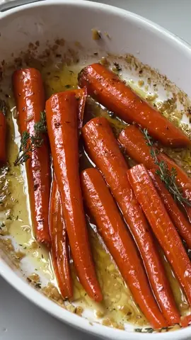 (Recipe Below)✨✨Maple Glazed Roasted Carrots are perfect for fall!  Ingredients 1 lb large carrots 2 garlic cloves, minced 3 tbsp unsalted butter 1 tbsp light brown sugar 3 tbsp pure maple syrup 1/2 tsp fresh thyme, finely chopped Salt & Black pepper Instructions First set the oven to 400 degrees. Next peel the carrots, trim off the ends, and cut in half lengthwise. Place the carrots in a large roasting pan or dish. Then add the light brown sugar, maple syrup, and fresh thyme to a small bowl. Add salt and pepper.  Combine evenly. Pour the maple mixture over the carrots in the baking dish.  Toss to combine thoroughly.  Next slice the butter into thin slices.  Place the thin slices on top of the carrots. Roast for 40-50 minutes, tossing one or two times throughout. Roast until the carrots are fork tender. Remove the carrots from the oven.  Toss one last time and add salt and pepper to taste. Serve and enjoy! #roastedcarrots #mapleglazecarrots #mapleroastedcarrots #veggiesidedish #sidedish #siderecipe #fallrecipe #Recipe #recipevideo