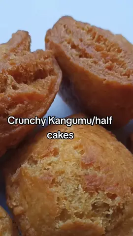 How to make half cakes/ 'ngumu'. These are crunchy on the outside and soft inside.  Ingredients. 3 cups Flour. 1Tbsp margarine. 1Tbsp baking powder. 1/2 tspn baking soda(bicarbonate of soda.) 1 1/2 cups of Milk. Sugar. • After kneading the dough proceed to frying. No need to rest the dough.  • The dough shouldn't be too soft. It should be slightly hard.  • Start frying when the oil is just warm. Cook the half cakes on low heat first. After they start cracking you can add the heat to ensure they cook all the way through.  • After frying the first batch let the oil cool slightly before frying the second batch.  • Don't put too much baking soda or it could leave a bitter after taste.  #frieddonuts #mandazirecipe #mahamrirecipe #kenyansnacks #kenyanfood🇰🇪🇰🇪🇰🇪 #kenyanfoodblogger #kenyanfoodie #kenyanfoodies #kenyanfoods #tastysahani#kangumurecipe #halfcakesrecipe 