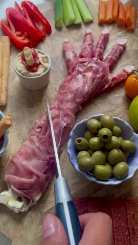 DID YOU KNOW 💀 The Halloween countdown has begun!  To get into the spirit 👻 we made a SEVERED ARM Charcuterie board! Our spooktacular Halloween bash is going to be hauntingly good, brimming with eerie and creative treats! 🎃 Follow @cookingwithkidsco for a ghoulishly good time, and make sure to save this post for some creepy culinary inspiration! How to make a Severed Arm Charcuterie Board for the BEST food reveal reactions EVER!!!! 1) draw around your arm (or a child's arm... preferably your own and not a random stranger's) on some parchment paper then cut out 2) get some hard cheese (cheddar/Edam etc) and wrap some cold cuts around it to form the fingers. The redder the meat, the better! (Parma ham, Prosciutto or Bresaola work best) 3) Use soft cheese to make the arm, like Brie! 🧀  4) Fill in the gaps using soft cheese like @boursincheese and a spatula to smooth it out 5) get the kids to cover the arm with the cold cuts, layer by layer. The messier the better! It looks more realistic! Then tuck the sides in 6) Use sliced chicken frankfurter sausages to shape the nails! 7) surround with other sharing platter bits like beetroot crackers and salsa to add to the gruesome effect 8) Present and enjoy the look on everyone's faces when you cut into the arm!! Happy Halloween planning! 👻  @Tasty @Food Network @foodpandaph   #kidsrecipes #halloween #halloweenfood #halloweenrecipes #halloweenfoodideas #severedarm 