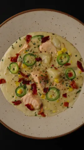Creamy Salmon Chowder 🍲   ❂ Ingredients: 1.5 lb Salmon fillet, skinless, cut into chunks 2 Potatoes, diced 3 Celery stalks, chopped 1 cup Yellow corn 1 Jalapeño pepper 1 bunch Scallions  1 Onion finely chopped 3 Garlic cloves, minced 1 Tbsp Cornstarch  1 qt Chicken or vegetable broth 1 cups Heavy cream 3 slices Bacon Butter: 2 tbsp Salt and black pepper: to taste ❂ Cooking process:  ⁃ Sauté: In a large pot, fry the bacon. Remove the bacon and set aside and saute in bacon fat onions, scallions, celery, jalapeno pepper, corn and garlic. Cook for 5-7 minutes until slightly tender.Add butter, than add cornstarch and mix well.   ⁃ Broth & Simmer: Pour in the broth. Add potatoes and bacon. Bring it to a simmer, and cook until veggies are soft (about 15-20 minutes).  ⁃ Creamy Base: Stir in the heavy cream, then gently add the salmon chunks. Cook for 5-7 minutes until the salmon flakes easily.  ⁃ Season & Garnish: Season with salt and black pepper. Finish with fresh jalapeño pepper and bacon.  ⁃ Serve: Ladle into bowls, and savor the comforting warmth of this Salmon Chowder. 🌟 Warm up your day with a bowl of Creamy Salmon Chowder, a perfect blend of flavors and textures. Comfort in every spoonful! 🥄 #salmonchowder #salmon #salmonrecipe #EasyRecipe #foodart 