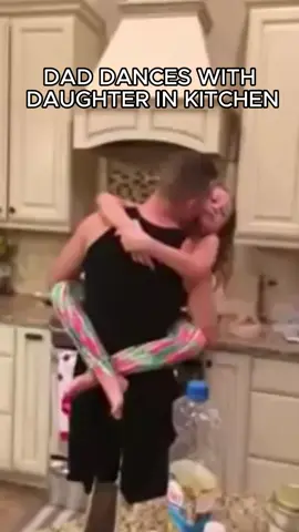 DAD DANCES WITH DAUGHTER IN KITCHEN
