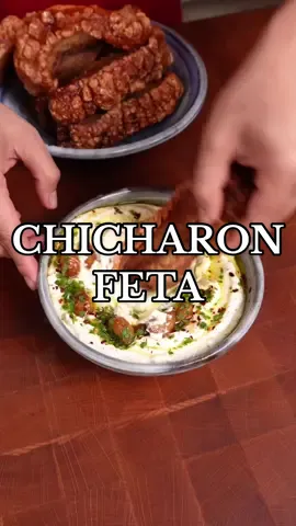 Chicharon w/ Feta dip 🐖 Here’s another kitchen experiment for you guys 😳 Verdict: It was very delicious but also sinful 😩 The rich and crispy pork belly paired well with the tangy feta dip. Would recommend but I think it would pair best with some sort of flat bread and herbs to cut through all that richness. It works though!! *note: this is not the traditional way of making chicharrones but rather a shortcut-ish you can do at home 🫶 INGREDIENTS: Feta Dip: - feta cheese - 2 whole roasted garlic - 1 lemon, juiced - 3 tbsp Olive oil - 3/4 cup Greek yogurt - Pepper Crispy pork: - 1kg pork belly (sliced lengthwise) - onion, garlic, bay leaves, peppercorns, salt INSTRUCTIONS: - Make crispy pork belly by boiling pork belly with onion, garlic, bayleaves, peppercorns and salt for around 20-30mins. Rub with salt and let dry overnight in fridge. - Air fry pork at around 175C for 40mins-1hr or until the skin is slightly hard but still has some resistance when you touch the skin. Remove and let cool. - In a pot with really hot oil >180C drop your pork belly pieces and cook for 3-5mins or until the skin is bubbly and crispy. Chop pork belly into cubes and set aside. - Make feta dip by combining all ingredients listed above for the dip in a food processor. Blend until smooth and creamy. #chicharron #cookingasmr #asmr #whippedfeta #crispyporkbelly #crispypork