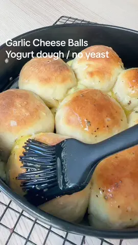 #bread #EasyRecipes #fyp  Bread dough:  300g plain flour  250g Greek yogurt  1.5 tsp baking powder  Filling: Favourite melty cheese  Garlic butter:  80g softened butter  2 - 3 x garlic cloves  Salt, pepper, dried herbs Mix the flour & baking powder together, add yogurt and mix well till combined using spoon and then your hand  Take dough out onto floured surface and knead for a couple of minutes. Leave dough covered on the side while you prep the filling. Chop the cheese into 8 cubes and mix the garlic butter ingredients together. Preheat oven to 220C  Chop the dough into 8 and flatten and fill as shown in the reel, butter first and then cheese, Pinch together tightly and a little roll. You should have a little butter leftover, save on the side (you don’t need much)  Add to a dish with greaseproof paper, bake covered with foil for 10 min and then another 15 - 20 min uncovered.  Just before you take them out heat the butter (I use the microwave for a few seconds) and brush over the balls Enjoy D xx 
