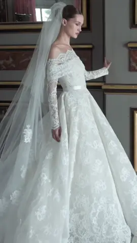 Delicate floral outlines of chantilly lace dance off shoulders and down lustrous sleeves, only to soften into ballgowns of voluminous proportion. Discover the ELIE SAAB Fall 2024 Bridal collection on www.eliesaab.com #ELIESAAB #ELIESAABBRIDAL #ESBRIDALFW24 #WHATTOWEAR #WEDDINGTIKTOK 
