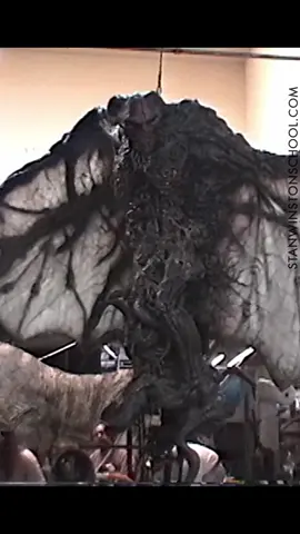 END OF DAYS - Testing the Seven-Foot Tall Satan Beast at #StanWinstonStudio.  #EndOfDays, Peter Hyams’ film about an ex-cop (Arnold Schwarzenegger) who faces off with Satan to prevent him from taking a bride and bringing about the prophecies in the Book of Revelations. One of a slate of movies that exploited the paranoia surrounding the coming end of the millennium — was much more somber in tone.  Stan Winston Studio designed and executed a full-size Satan beast as a suit and #mechanical head, which was intercut with a computer-animated Satan created by Rhythm & Hues. Joey Orosco #sculpted the beast, working from Crash McCreery’s drawings.  The final Satan beast measured seven feet tall and had a twelve-foot wingspan. For several days of filming, at a Catholic church in downtown Los Angeles, John Rosengrant performed inside the suit, while six to nine puppeteers controlled head and wing functions. “The Satan creature was probably the toughest suit I was ever in,” noted Rosengrant, “mainly because of the position my body had to be in to make it work. My arms were outstretched, and my feet were locked together in ski boots, on a little base on a boom arm so that I could be raised and lowered. I looked as if I was being crucified. Then, I had to lean far forward, which put a lot of pressure on my back, because the suit and the head were very heavy. I had to train really long and hard to sustain that kind of pressure on my back. It was also very claustrophobic in this suit. Once it was sealed up, there was no way to breathe, so I had to be fed air from a tube. It was dark in there, too so I couldn’t see a thing until the monitor inside was turned on.”  #puppet #puppets #practicaleffects #moviemaking #filmmaking #behindthescenes #arnoldschwarzengegger