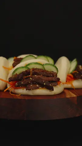 Korean Bao Buns 📕Recipe here  ❂ Ingredients: For the buns:  100g. Warm Milk 100g. Warm Water 10g. Active yeast  1 Tsp Sugar 1/2 Tsp Salt 3 Tbsp Vegetable oil 400g. All purpose flour For the filling: 450g. Beef steak 2 Tbsp Soy sauce 1 Tbsp Sesame oil  1 Tsp Paprika 1 Tbsp Gochujang paste 1 Onion  1 Cucumber Toasted sesame seeds For Pickled Carrot: 1 Carrot (Large)  2 Cloves of garlic Salt/Pepper to taste  1 Tbsp Vinegar 3 Tbsp Vegetable oil ❂ Cooking process:   ⁃ Bun Preparation: Combine Bao bun flour, warm water, warm milk, sugar, yeast, oil, and salt. Knead until smooth. Let the dough rise until doubled.  ⁃ Cook the Filling: Marinate beef in a mixture of soy sauce, sesame oil, paprika, salt/pepper. Cook until tender and flavorful, then stir in chopped onions.  ⁃ Shape and Steam Buns: Divide the dough into small rings, fold in half and steam 15 min until puffy and cooked through.  ⁃ Assemble: Open the buns and fill them with the cooked meat. Add garnishes like sliced cucumbers, pickled carrots and sesame seeds. Serve and Enjoy: Serve these Korean Bao Buns hot and enjoy the fusion of savory flavors and soft, pillowy textures. Transport your taste buds to the streets of Seoul with these homemade Bao Buns, a perfect blend of sweet, savory, and umami flavors. Happy cooking! 🎉 #baobuns #korean #koreanfood #meat #meatlover #steak #beef 