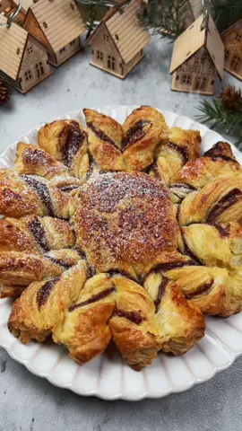 Part 150. Puff Pastry Snow Flake with Nutella. A quick dessert for the holidays.                                                   Ingredients 2 sheets puff pastry 1/2 cup Nutella  1 egg  1 tbsp powder sugar  2 tbsp decorative sugar ( optional)  Direction 1. Preheat the oven to 425F.  2. Roll out your dough. Trace the puff pastry sheet with a bowl or plate to make two circles.  3. Spread the Nutella onto the bottom sheet. Cover it and use a small bowl as a place holder. Divide the pastry sheet into four sections.  4. Cut four little sections into each quadrant.  5. Brush with egg wash and sprinkle the sugar if you have it.  6. Twist the pastry opposite of each other and join them at the bottom.  7. Bake for 18 minutes and dust with powder sugar.  #dessert #bakingrecipe #baking #Recipe #EasyRecipe #holidayrecipe #christmasrecipe 
