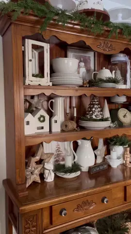 I’ve got the itch to paint this hutch!! 🫣 Help! Should I do it? And I got my plate rack ready for Christmas!! Lots of woods and whites!! 🥰 #cottagechristmas #hutchdecor #breakfastnook #christmasdecor #tistheseason
