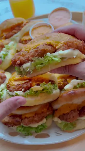 CHICKEN BURGERS #chicken #burger #food #Recipe #tiktokfood #fy #tasty #foryou #fyp #foryoupage   DOUGH 420 g flour (all-purpose flour) 7 g instant yeast (1 tablespoon - dry yeast) 15 g granulated sugar 7 g salt (1⅙ teaspoons) 25 g unsalted butter 1 egg (m) 40 ml sunflower oil 190 ml milk   CHICKEN MIXTURE 400 g chicken breast 100 ml Greek yogurt 75 ml milk 7 g onion powder (2⅓ teaspoons) 3 g paprika powder (1 teaspoon) 2 g black pepper powder (⅔ teaspoon) 2 g cayenne pepper powder (⅔ teaspoon) 8 g salt (1⅓ teaspoons) 10 g sambal 30 g honey 1 egg (m)   EXTRA 1 egg (m)   FLOUR MIXTURE 75 g flour (all-purpose flour) 75 g cornstarch 3 g salt (½ teaspoon) 5 g onion powder (1⅔ teaspoons) 2 g black pepper powder (⅔ teaspoon)   Heat the unsalted butter in a saucepan over low heat and let it cool slightly.   In a deep bowl, combine the flour, sugar, yeast, salt, melted butter, beaten egg, sunflower oil, and (lukewarm) milk. Mix well and knead for 10-12 minutes until smooth.   Cover the dough and let it rise in a warm place for 1 hour or until the dough has doubled in size.   In a deep bowl, combine the Greek yogurt, milk, onion powder, paprika powder, black pepper, cayenne pepper, salt, honey, sambal, and beaten egg. Mix until well combined. Scoop out 50 ml of the yogurt mixture and set it aside.   Wash and cut the chicken into pieces and place them in the yogurt mixture. Cover and refrigerate for 30 minutes (or longer).   In a bowl, combine the flour, cornstarch, salt, onion powder, and black pepper. Add the reserved yogurt mixture (50 ml). Crumble together using your hands. Set aside.   Release the air from the dough and divide it into 15 equal pieces (48 grams each). Shape them into balls.   Take a ball and flatten it with a rolling pin (12 by 10 cm). Fold the dough in half.   Place the dough on a baking sheet lined with parchment paper. Brush them with the beaten egg.   Let the dough rise for 30 minutes or until it has doubled in size.   Dredge the chicken pieces in the flour mixture and place them on a sheet of parchment paper.   Heat a layer of sunflower oil in a frying pan over medium-high heat (170 ℃). Fry the chicken until crispy and golden brown on both sides. Drain the crispy chicken pieces on a sheet of kitchen paper.   Place the buns in a preheated oven at 200 ℃. Bake for 12-18 minutes or until the buns are nicely golden brown. Keep an eye on the baking time as every oven works differently. Immediately cover the buns with a clean kitchen towel as they come out of the oven to keep them soft.