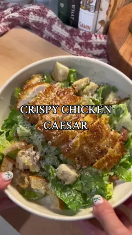 Crispy caesar salad just hits diff Salad: -2 cups romaine -handful of cherry tomatoes, quartered -handful of croutons -salt and pepper to taste -Caesar dressing -crispy chicken  -parmesan cheese to top Dressing: -1/2 cup mayo -1/4 cup grated parm -3 cloves minced garlic -1 tbsp lemon juice -1/2 tsp salt -1/2 tsp pepper -1 tbsp dijon musty -2-4 tbsp olive oil (depending on consistency you like) *Add all ingredients except for olive oil to a bowl and whisk until smooth. Add in olive oil 1 tbsp at a time while whisking.  Crispy Chicken: -butterfly your chicken breasts and pat dry -coat in flour, shaking off any excess -coat in whisked egg, letting any excess drip off -coat in bread crumbs (I use panko bread crumbs and add some salt, pepper, garlic powder, onion powder, and parmesan cheese) -coat again in egg -coat again in bread crumbs -heat up some vegetable oil in your skillet over medium high. Once it is hot enough, add your chicken cutlets. Make sure to lay them away from you so the oil does not splash up in your direction. -let cook for about 3-4 minutes before flipping and cooking for another 3-4 minutes on the other side.  -I use a meat thermometer to ensure chicken is fully cooked to 165 internal.  -let rest about 10 minutes before cutting #caesarsalad #caesar #chickencaesarsalad #crispychickencaesar #salad #saladideas #saladrecipes #saladfordinner #easydinnerideas #easydinner #easydinnerrecipes #dinnerrecipes #cooking #dinner 