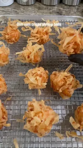 CRISPY DIM SUM SHRIMP BALL Another great finger foods for holidays, party or potluck. Can be made in advance for 1-2 day or freeze for whenever.  Recipe: how many depends on the size of your shrimp balls. I usually scoop about 1 tablespoons of minced shrimp for each ball.  Recipe: •2 lbs minced shrimp 🍤  •1 pk spring roll wrap  •1 teaspoon salt  •1 teaspoon sugar  •1/2 teaspoon msg(op) •1/2 teaspoon ground pepper  •1/2 teaspoon garlic powder  •1/2 teaspoons onion powder  •1 tablespoon cornstarch. You can double or triple the recipe  1•Add everything together and mix well.  2•Peel 5-6 pieces of spring roll wrap at a time. Fold and cut into thin strips. Fluff it out. If it’s too long give it a few rough cut. You probably only need half a package of wrap. Leftover can be store back in the freezer for later use.  3•Scoop in the shrimp paste. Cover the top with the wrap. Use your hand to squeeze into a ball. Continue until all done. 4•Preheat oil at 400f. Fry for 5-6 minutes or until golden. I’m using my famous/viral Presto 2.75 quart big kettle fryer from Walmart 😂  5•Removed into a cooling rack.  #nuocmamafoods #shrimp #shrimps #shrimpballs #dimsum #dimsums #fried #friedfood #fry #deepfry #Recipe #foodporn #snacks #streetfood