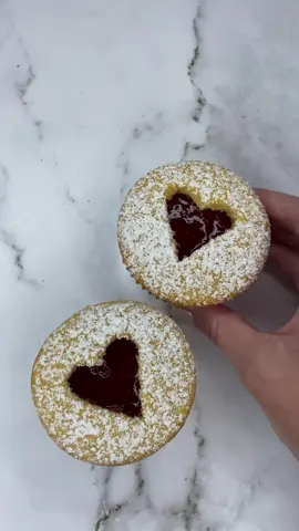 Linzer cupcakes ❤️🫶🏼🧁 I made almond flavoured cupcakes 🧁 but you could use any flavour. Fill the liners until almost full to get the larger dome on top. Bake for 25-30 minutes (170c fan) Once cooled, carefully cut off the tops and use a small heart cutter to cut out the shape in the centre. Dust the tops with icing sugar now (before you place them on the cupcake) Add strawberry & jam to the top of the cupcakes and then pop the tops back on. You can then add more jam to the cut out heart shape. These taste amazing, and would be even nicer with a dollop of fresh cream. Enjoy ☺️ ❤️☺️ #cupcake #cakedecorating #linzer #linzercupcakes #baking #bakingaesthetic #EasyRecipes #cakedbyrach #valentinesbaking #tutorial