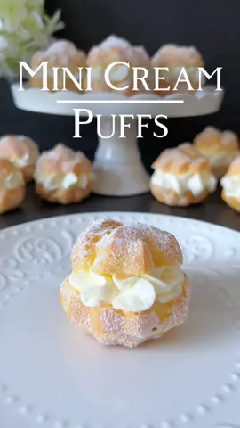 Mini Cream Puffs Recipe 🤍 These delicate treats, filled with airy whipped cream and a touch of powdered sugar, embody the essence of traditional baking! ☺️🤍 📝 Ingredients:    For the Choux Pastry: - 60g Butter - 150ml Water - 75g All-Purpose Flour - A Pinch of Salt - 2 Eggs (Size M)   For the Filling: - 350ml Whipped Cream - 2 Tablespoons Powdered Sugar - Fresh Berries or Powdered Sugar for Garnish (Optional) 🤍 Preparation: 1. Preheat the oven to 200 degrees Celsius (Top and bottom heat, middle rack). 2. In a pot, bring water, butter, and salt to a boil. Add the flour all at once and stir until the dough comes away from the pot's bottom. 3. Remove the pot from the heat, let it cool, and add the eggs one by one while stirring constantly. The dough should be smooth and glossy. 4. Fill the choux pastry into a piping bag with a star tip. 5. Pipe small 5 cm wide portions of dough onto a baking sheet lined with parchment paper. 6. Place the mini cream puffs in the preheated oven. After 20 minutes, reduce the temperature to 180 degrees and bake for an additional 5-8 minutes until golden brown. Important: Do not open the oven door during baking to prevent collapsing. 7. After baking, turn off the oven, wait for 5 minutes, then wedge a wooden spoon into the oven door (carefully open a small gap) to allow the cream puffs to cool slowly and retain their shape. 8. Let the baked cream puffs cool completely. 9. For the filling, whip the cream with powdered sugar until stiff. 10. Slice the cream puffs horizontally and fill them with the whipped cream. 11. Garnish with fresh berries or dust with powdered sugar as desired. Enjoy these delightful mini cream puffs! ☺️🤍